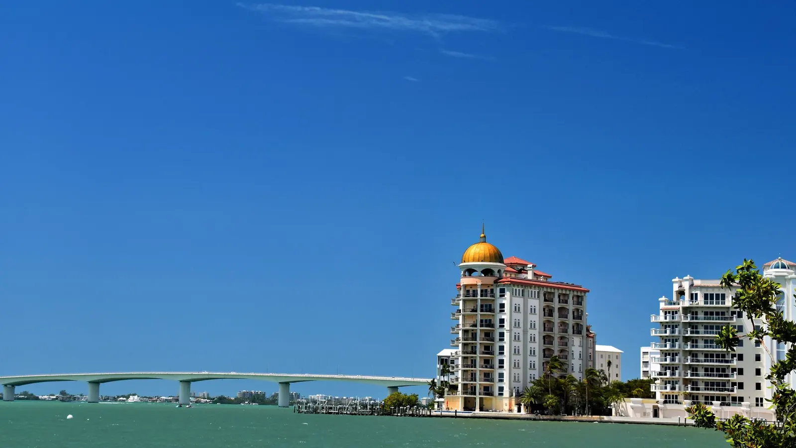 Sarasota bayfront with sailboats and the Ringling Bridge at dusk
