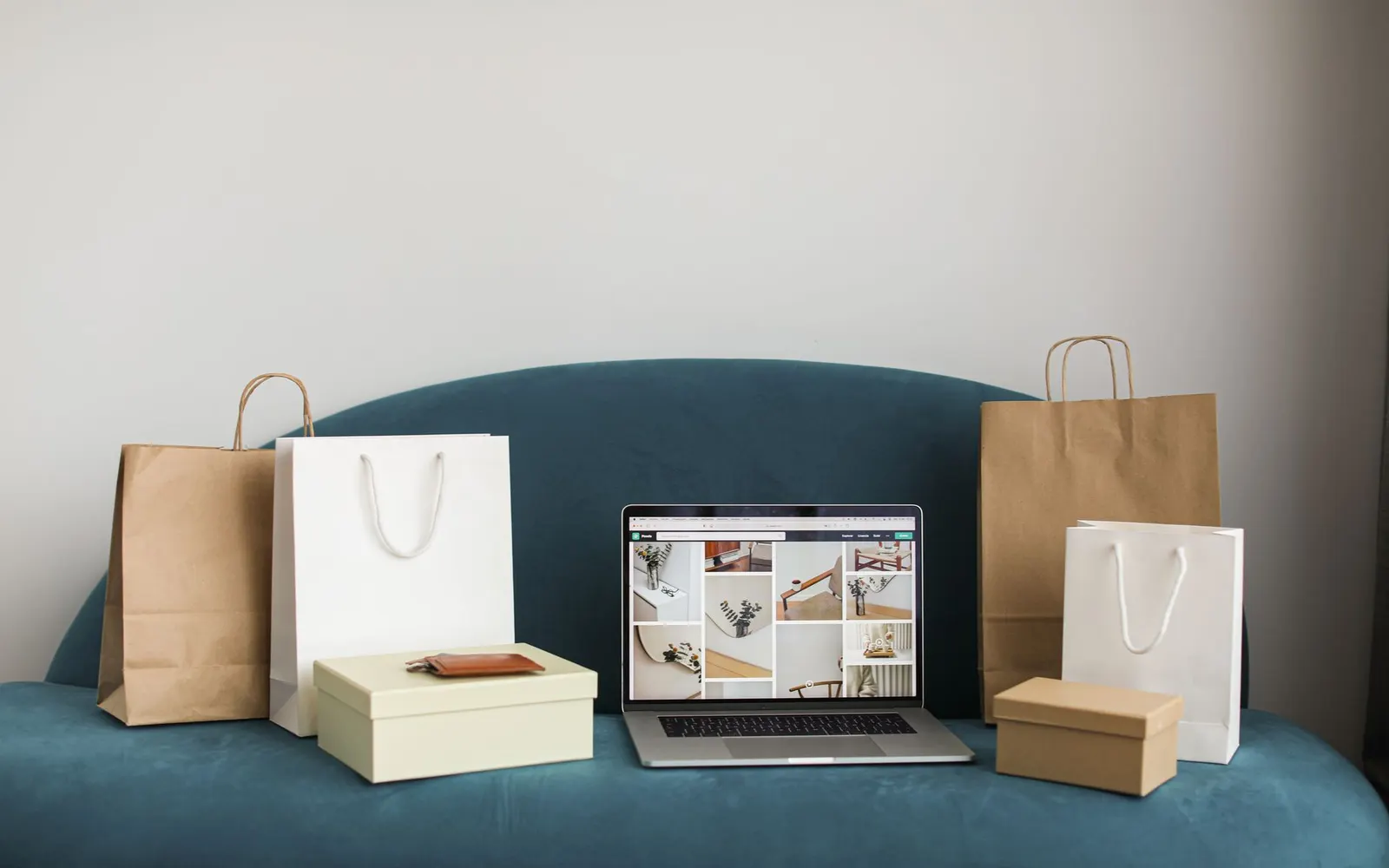 Laptop surrounded by shopping bags and boxes from online orders